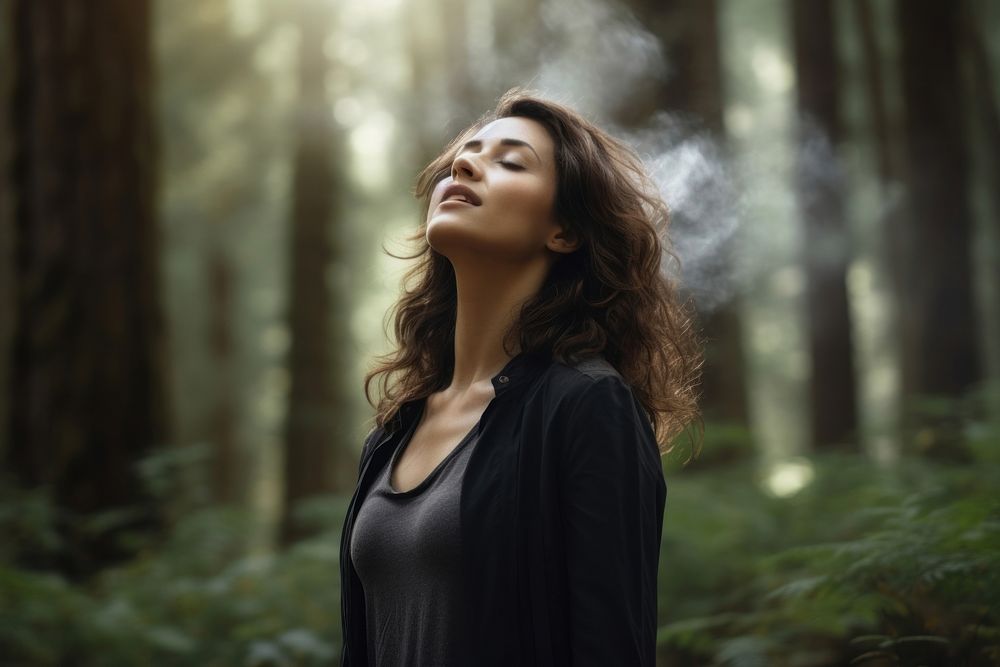 Woman smelling the air in the forest smoking smoke adult. AI generated Image by rawpixel.
