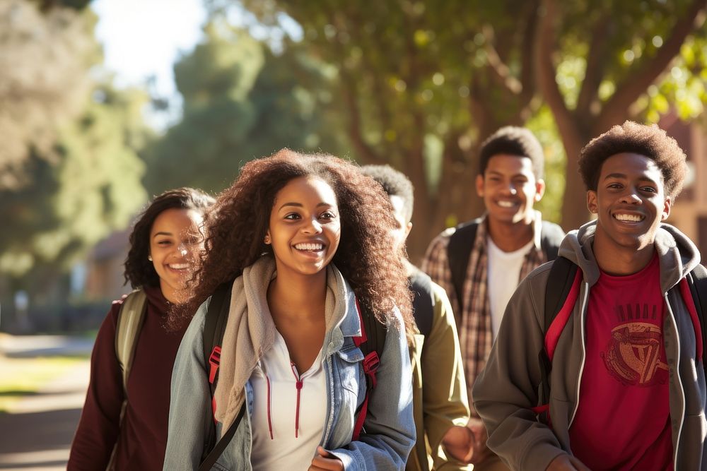 African student teens walking talking laughing outdoors campus. AI generated Image by rawpixel.