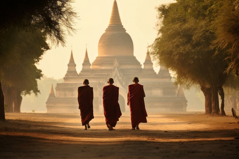 Monks are walking on dirt path in front of a temple in the background spirituality architecture silhouette. AI generated…