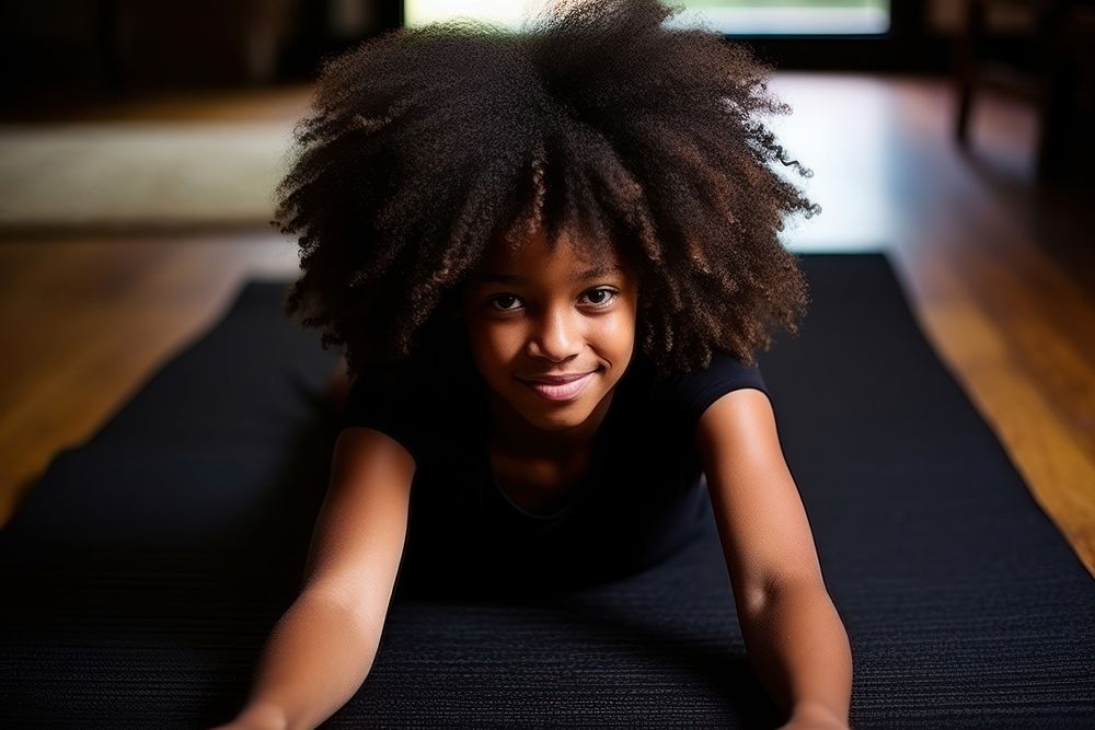 Blackgirl streching on yoga mat portrait child photo. AI generated Image by rawpixel.