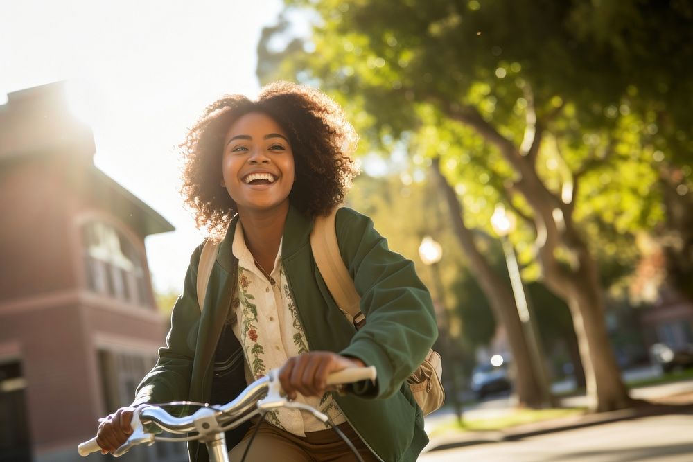 Happy African American female student cycling laughing bicycle vehicle. AI generated Image by rawpixel.