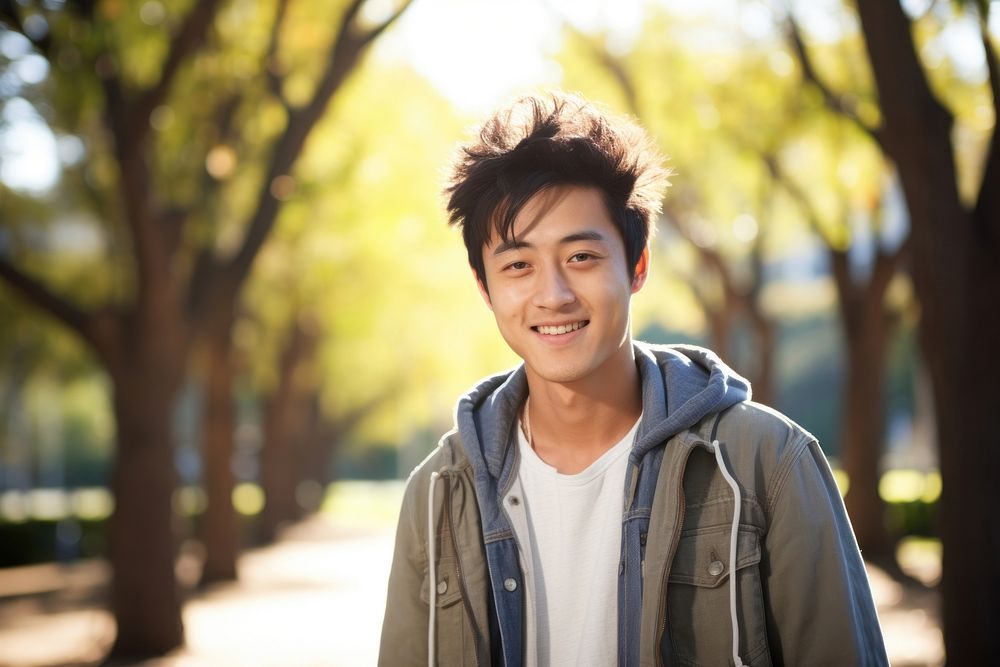 Smiling chinese guy in park portrait smile photo. AI generated Image by rawpixel.