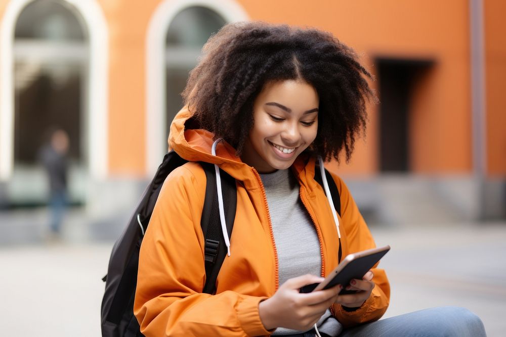 Smiling African female student in backpack looking at tablet sitting street adult. AI generated Image by rawpixel.