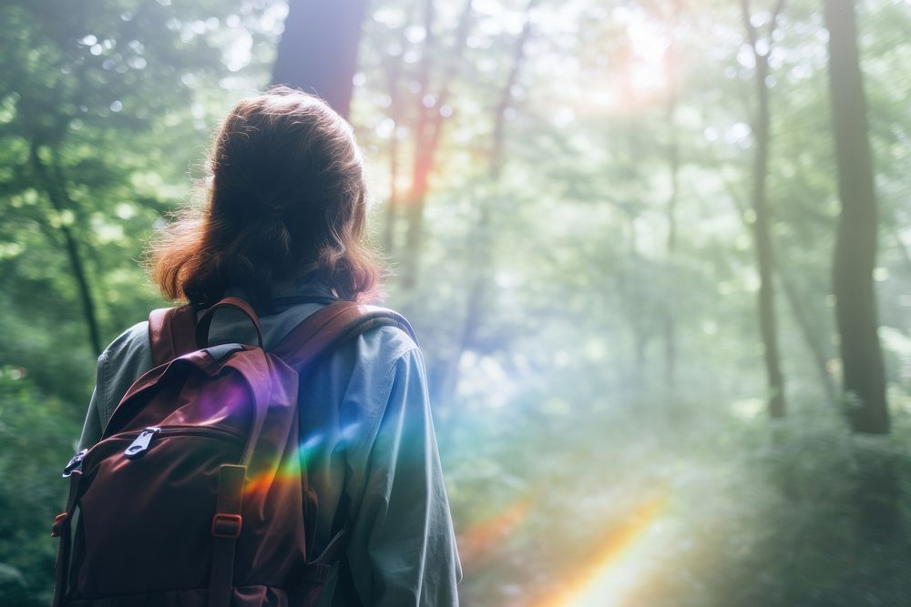 A woman with a backpack take a breath forest adventure sunlight. AI generated Image by rawpixel.