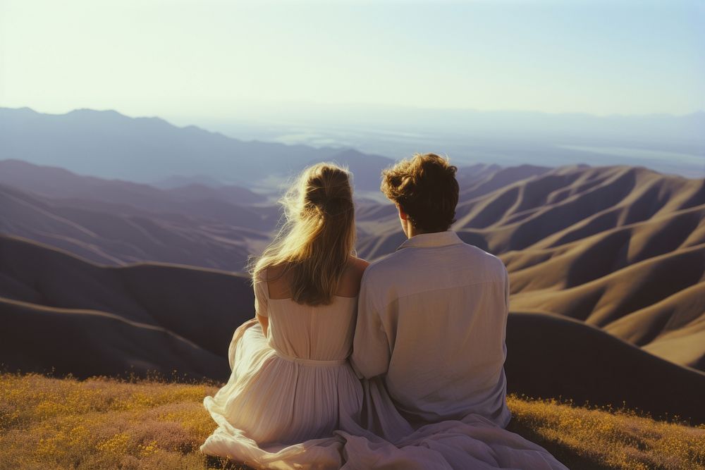 A hippie couple wearing wedding dress with hills background photography landscape outdoors. AI generated Image by rawpixel.