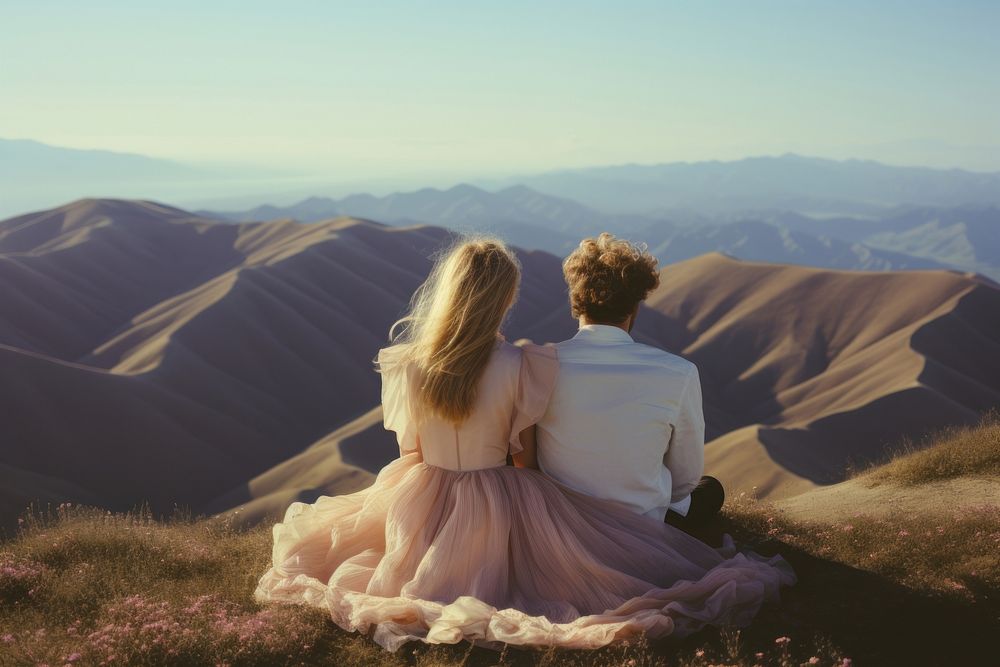 A hippie couple wearing wedding dress with hills background landscape photography wilderness. AI generated Image by rawpixel.