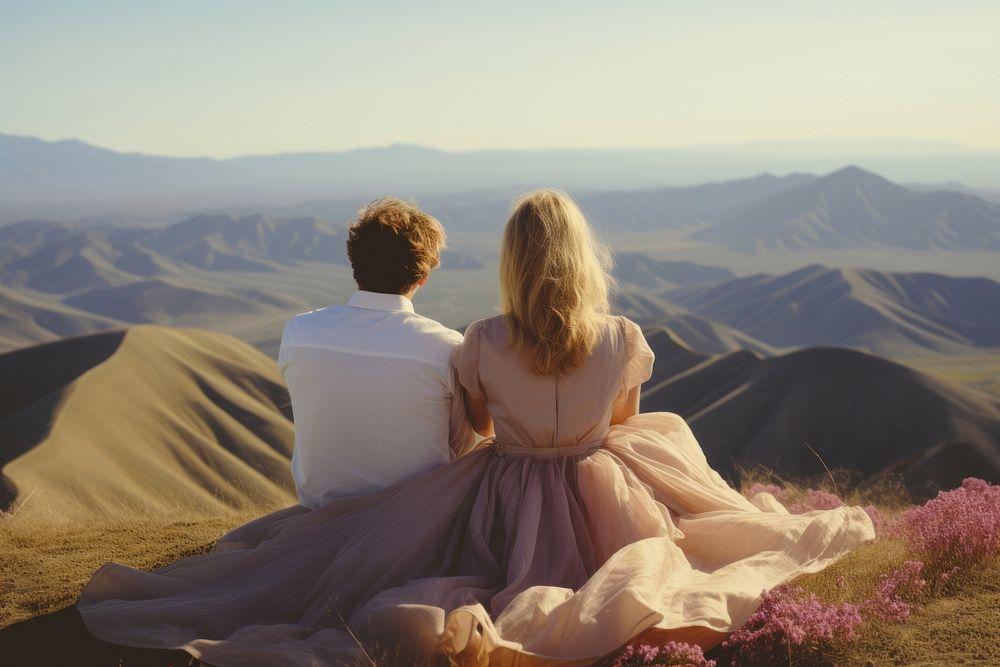 A hippie couple wearing wedding dress with hills background landscape outdoors romantic. AI generated Image by rawpixel.