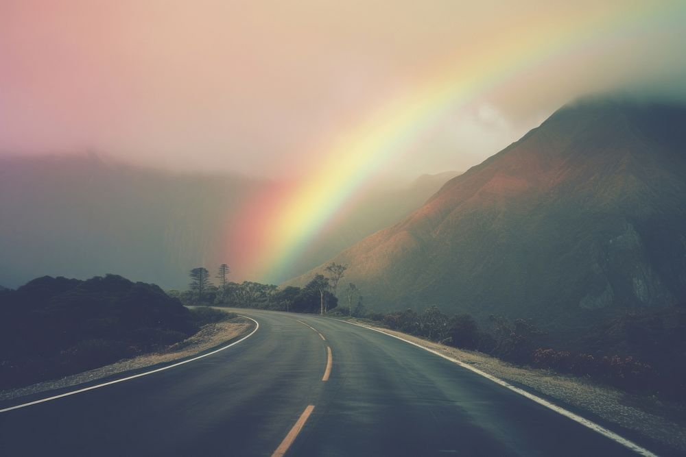 A road wwith a mountain in the background rainbow outdoors highway. AI generated Image by rawpixel.