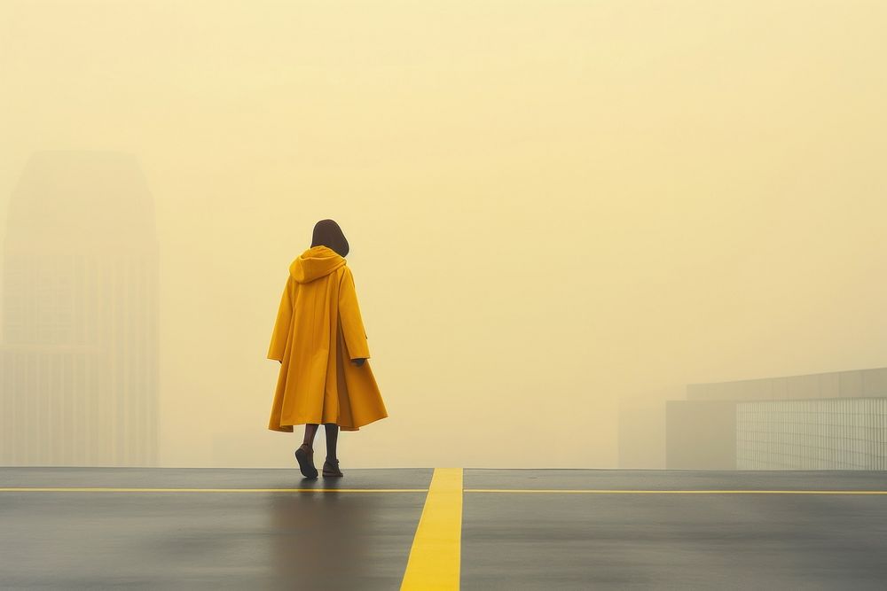Walking in rain coat outdoors yellow. AI generated Image by rawpixel.