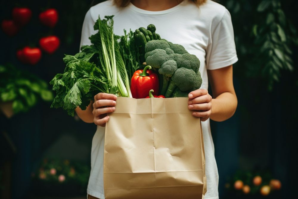 Woman hold paper bag vegetable plant adult. AI generated Image by rawpixel.