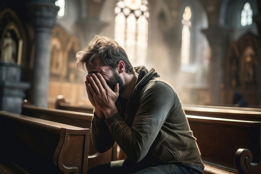 Hopeless man crying talking to god in church worried adult disappointment. 