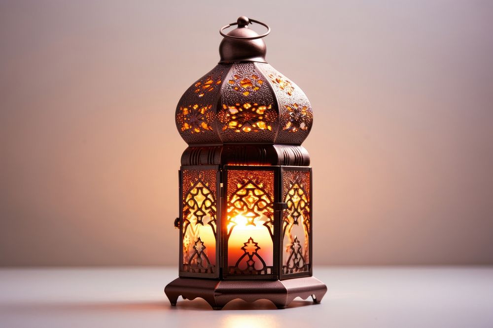 Ornamental Arabic lantern with burning candle glowing lamp illuminated decoration. AI generated Image by rawpixel.