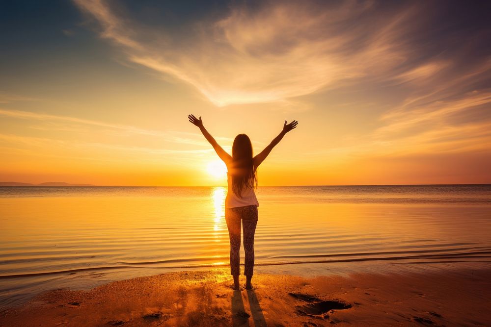 Happy woman with arms up enjoy freedom at the beach at sunset travel happy spirituality. AI generated Image by rawpixel.