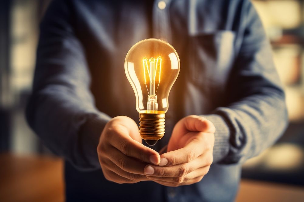 Hand holding light bulb lightbulb adult electricity. AI generated Image by rawpixel.