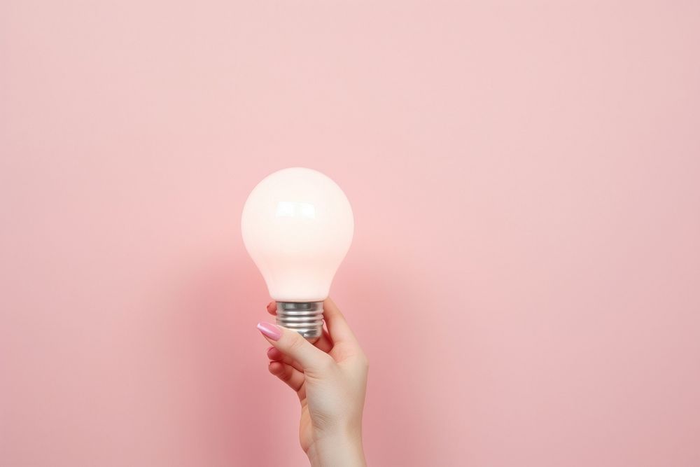 Hand holding light bulb lightbulb electricity illuminated. AI generated Image by rawpixel.