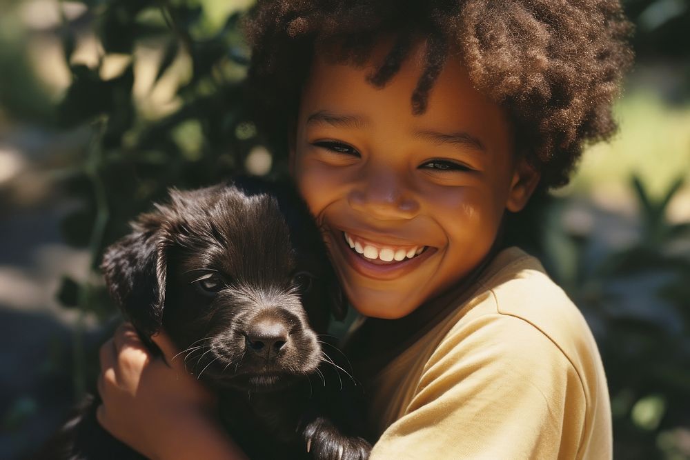 A little black kid hug a puppy dog pet photography. 