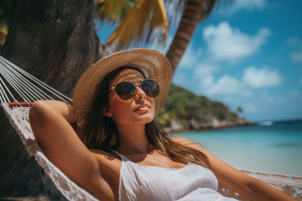 Woman sleeping in a hammock under the coconut tree on the beach glasses sunbathing vacation. AI generated Image by rawpixel.