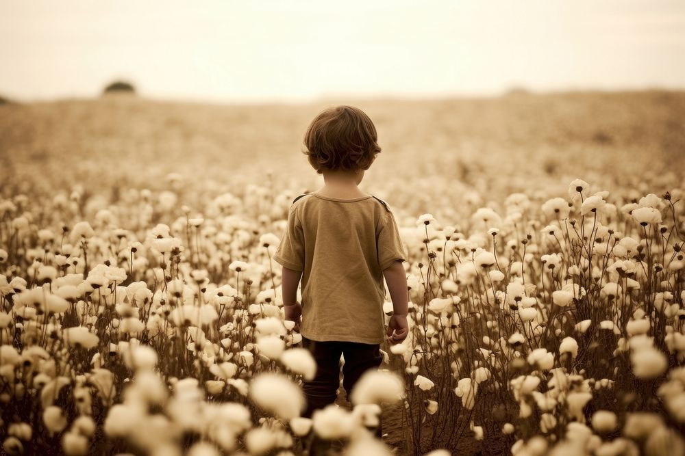 Little boy in a flower field photography portrait outdoors. AI generated Image by rawpixel.