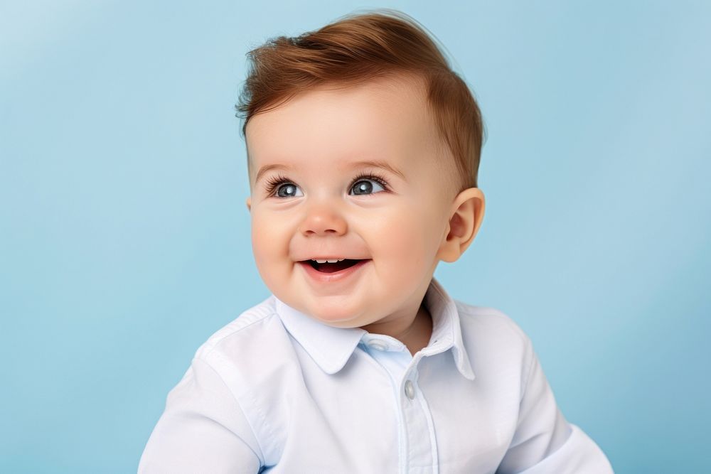 Little toddler boy sitting and laughing portrait baby smile. AI generated Image by rawpixel.