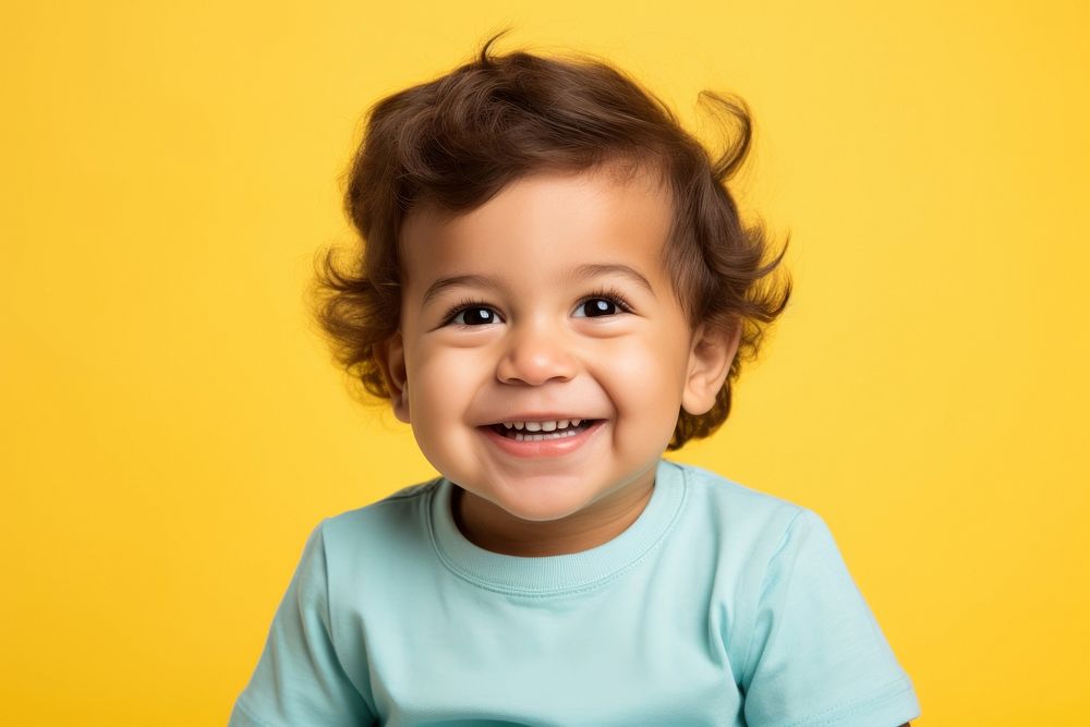 Little toddler boy sitting and laughing baby portrait smile. AI generated Image by rawpixel.