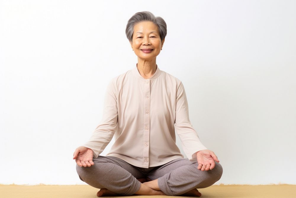 Asian senior woman doing yoga meditation sitting adult cross-legged. AI generated Image by rawpixel.