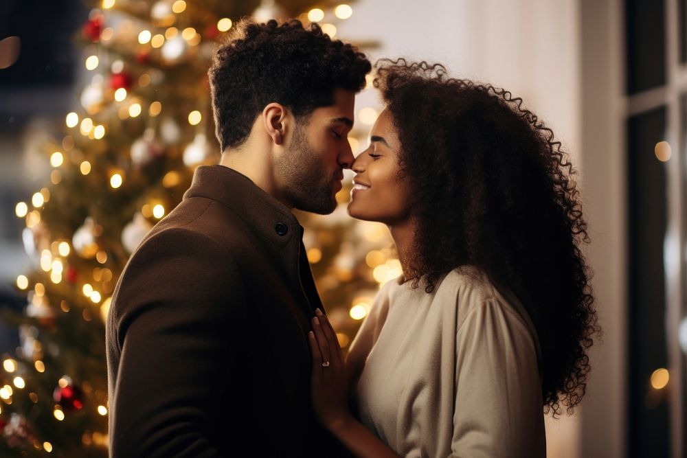Couple kiss by a christmas tree photography portrait romantic. AI generated Image by rawpixel.