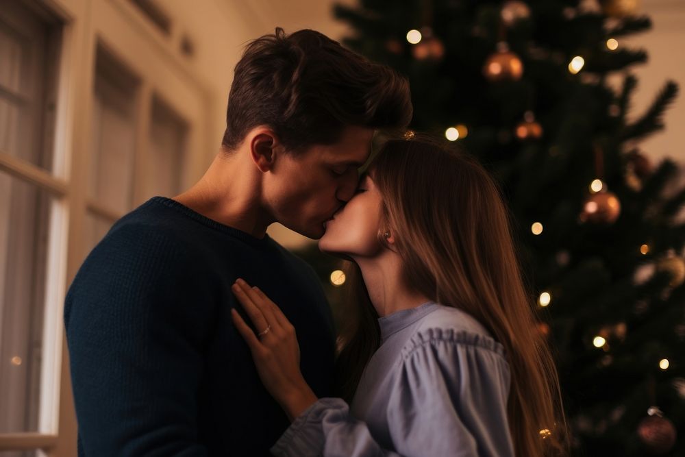 Couple kiss by a christmas tree photography romantic romance. AI generated Image by rawpixel.
