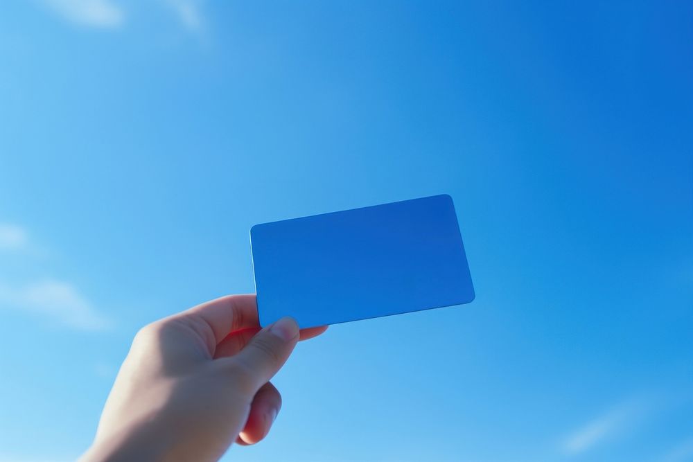 Credit card holding hand blue. AI generated Image by rawpixel.