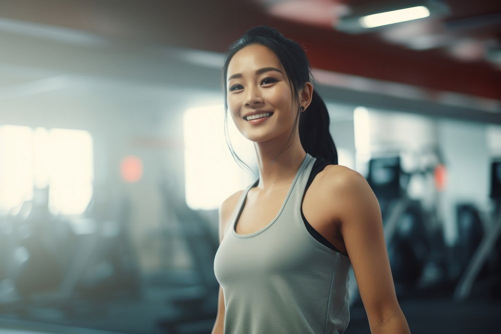 Asian woman in sportswear walking in a gym smiling adult determination. AI generated Image by rawpixel.