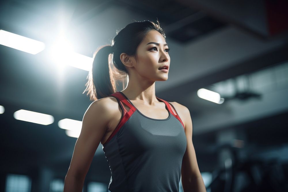 Asian woman in sportswear walking in a gym adult determination bodybuilding. AI generated Image by rawpixel.