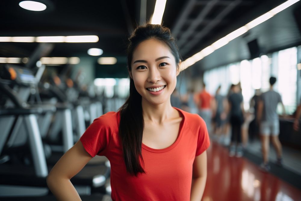 Asian woman in sportswear walking in a gym smiling smile adult. AI generated Image by rawpixel.