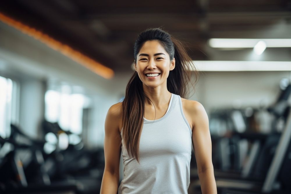 Asian woman in sportswear walking in a gym smiling smile adult. AI generated Image by rawpixel.