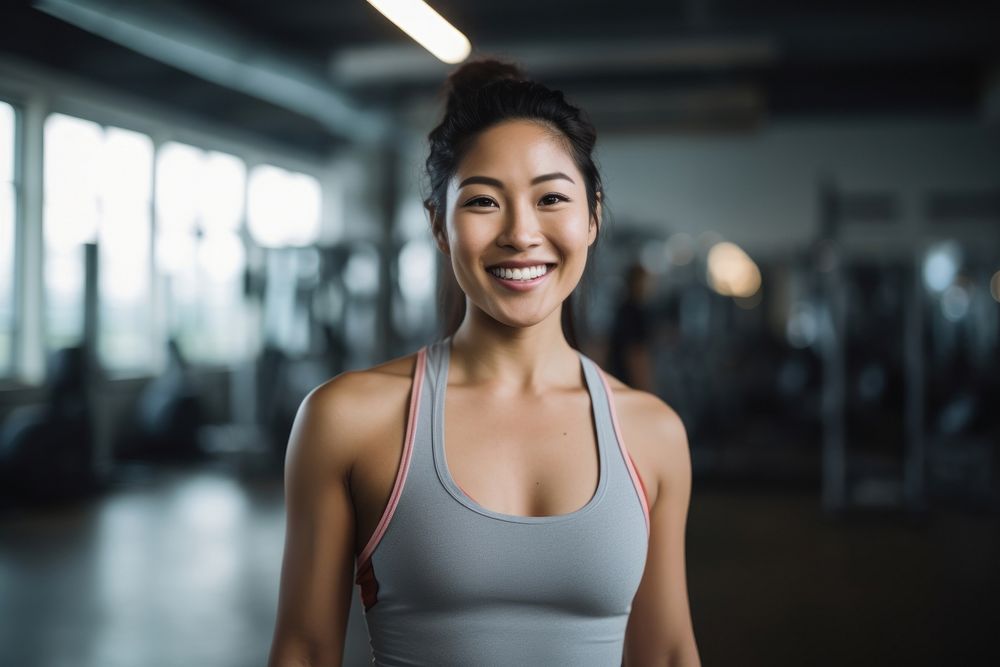 Asian woman in sportswear walking in a gym smiling smile adult. 