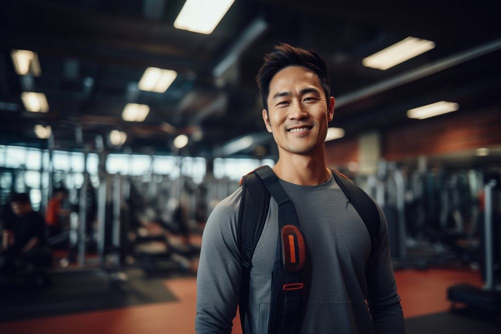 Asian man in sportswear walking in a gym portrait smiling adult. AI generated Image by rawpixel.