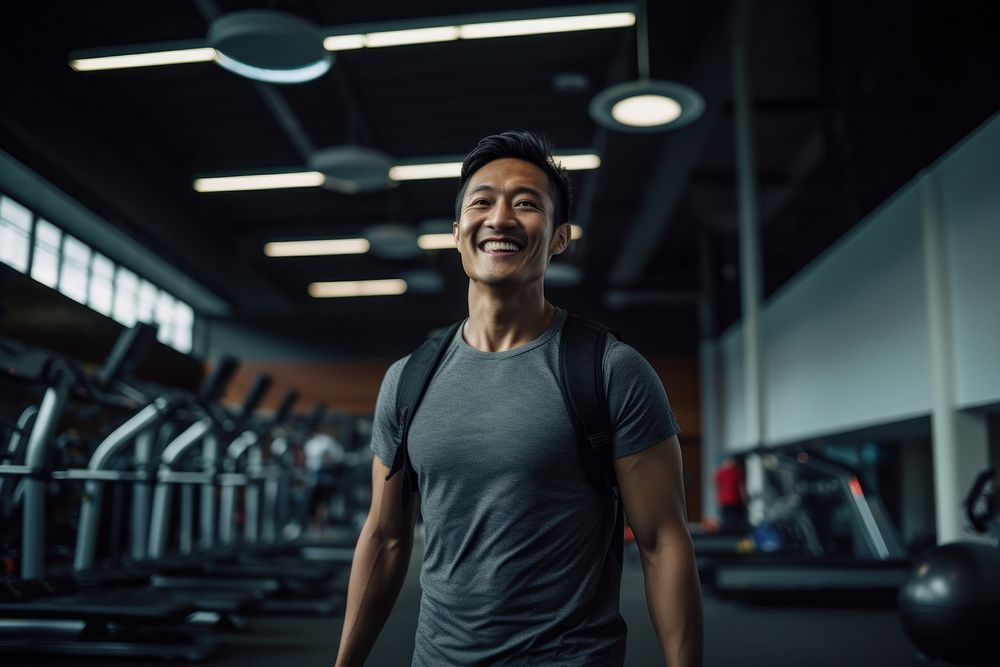 Asian man in sportswear walking in a gym smiling fitness adult. AI generated Image by rawpixel.