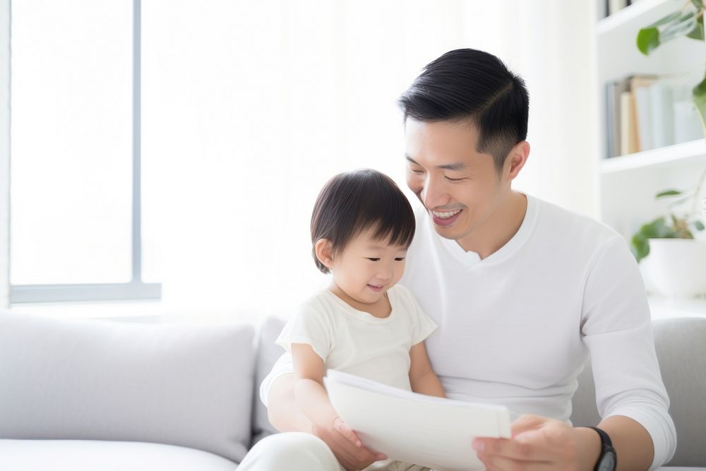 Asian family sitting reading holding. AI generated Image by rawpixel.