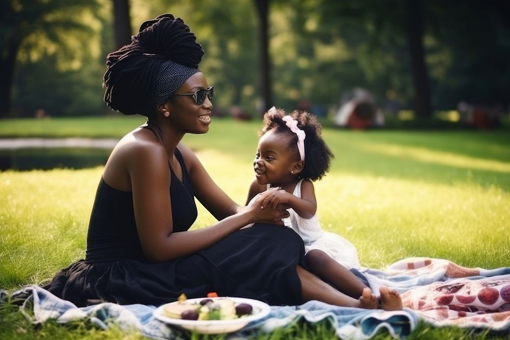 Black mother and child sit picnic in a park photography portrait family. AI generated Image by rawpixel.