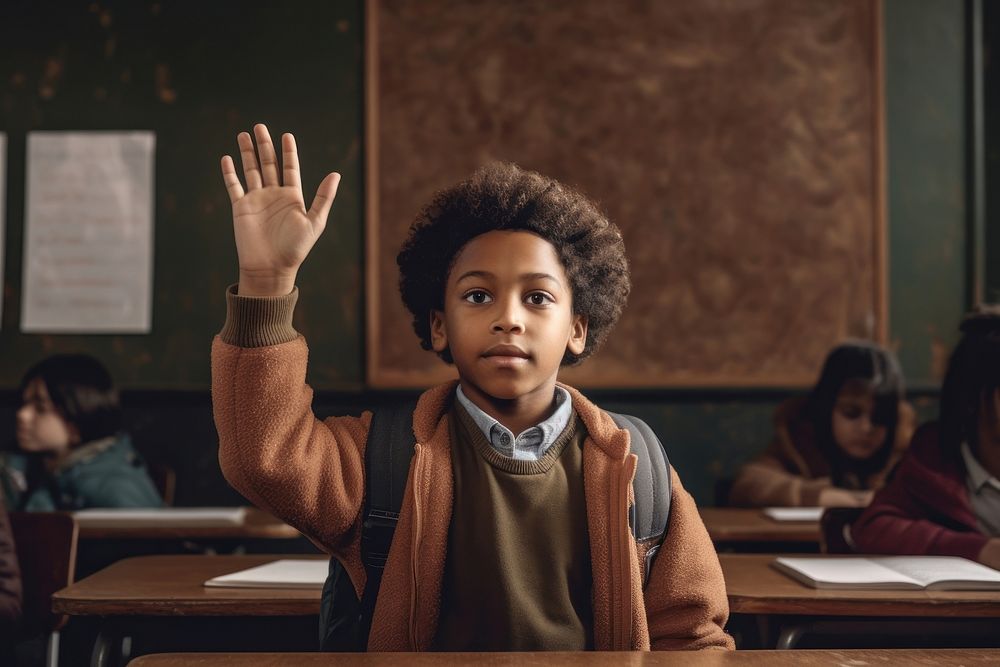 An african american boy raises his hand in his class blackboard classroom portrait. AI generated Image by rawpixel.