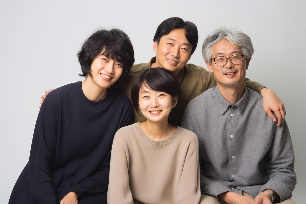 Japanese family poses at studio for portrait pictures grandparent adult togetherness. AI generated Image by rawpixel.