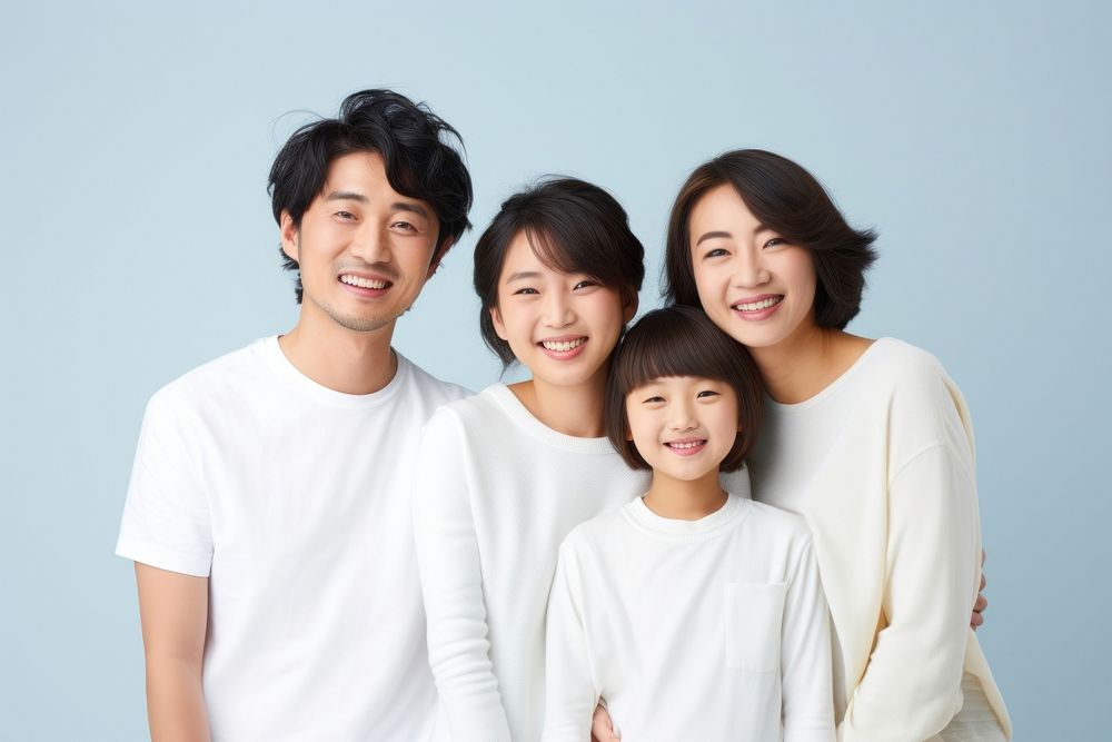 Japanese family wearing blank white shirt poses at studio for portrait pictures parent adult togetherness. AI generated…