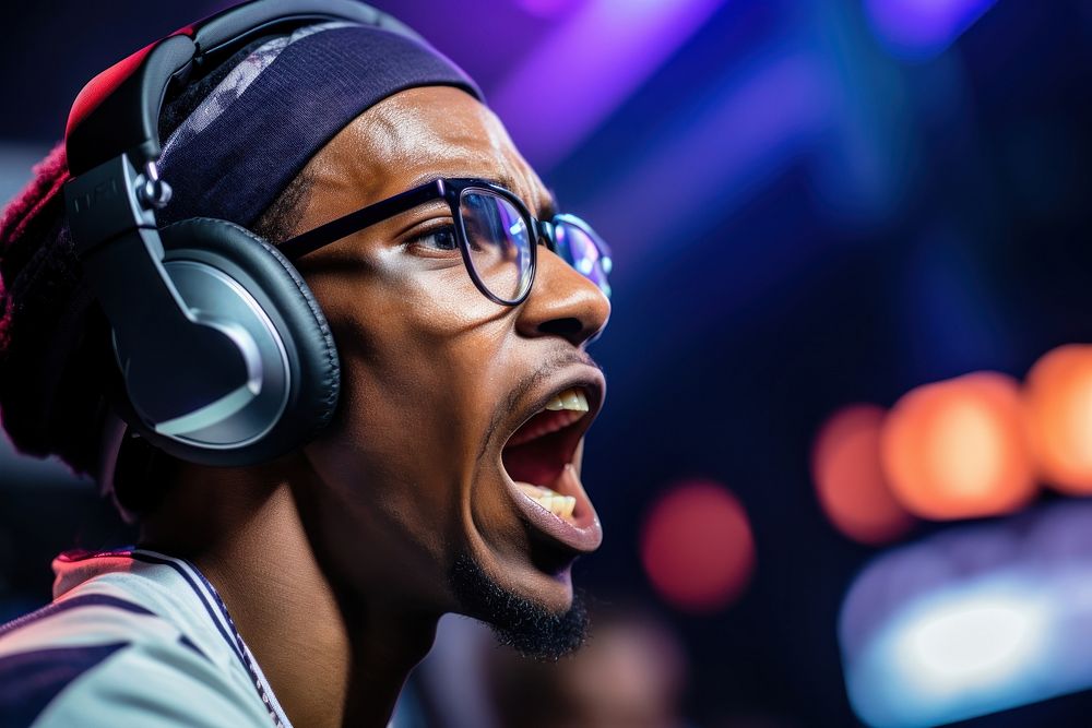 Black male wearing headphone gaming and eyeglasses in game tournament headphones shouting sports. AI generated Image by…