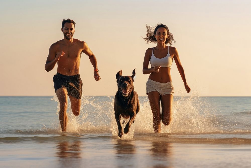 Dog and beach with a black couple running animal pet. AI generated Image by rawpixel.