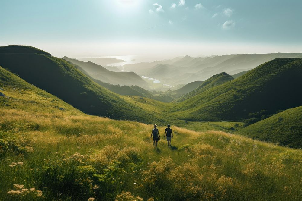 Two people hiking grass wilderness landscape. AI generated Image by rawpixel.