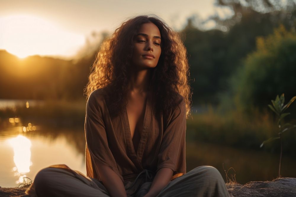 Woman meditating sunset adult contemplation. AI generated Image by rawpixel.