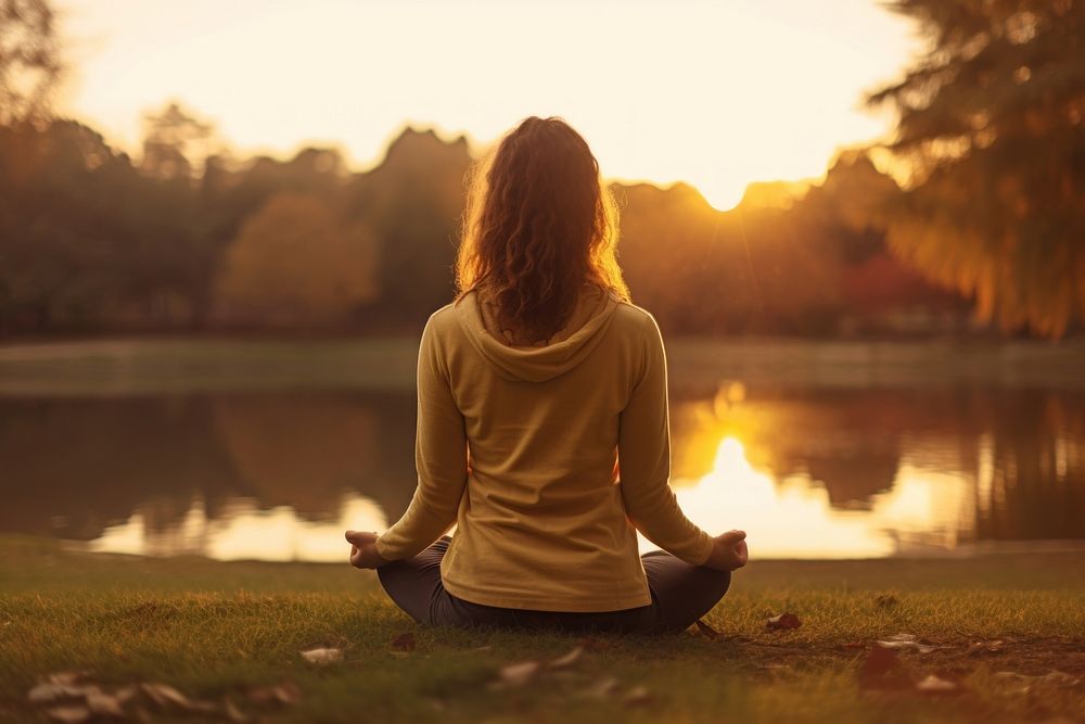 Woman meditating sitting sunset sports. AI generated Image by rawpixel.