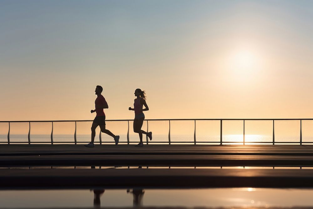 A couple jogging on seaside in summer day early morning running tranquility silhouette. AI generated Image by rawpixel.