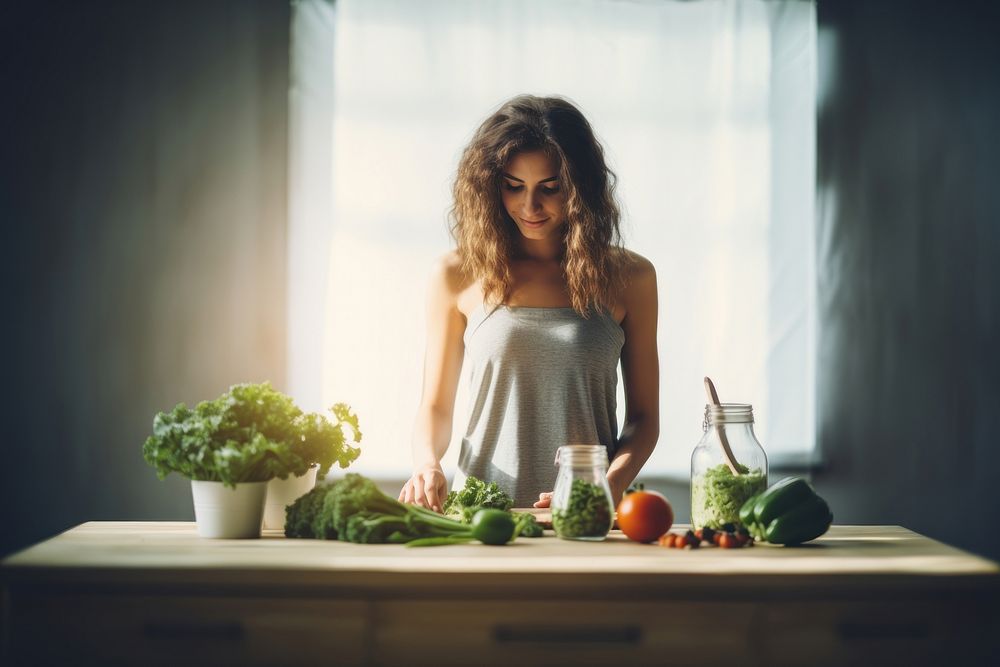 A Sporty young woman is preparing healthy food on light kitchen adult green hairstyle. AI generated Image by rawpixel.
