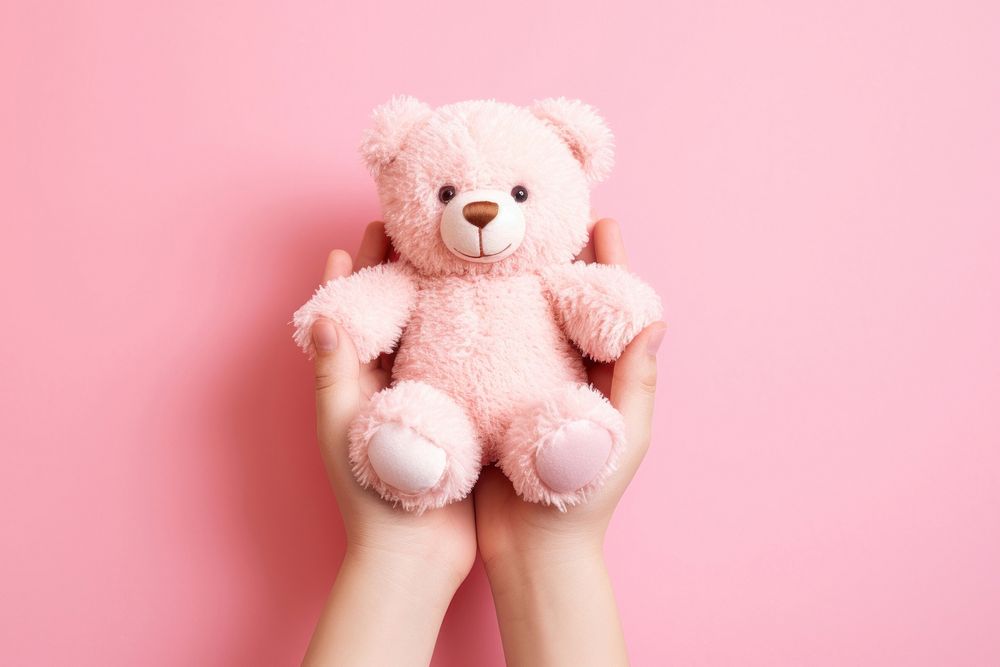 Baby hands holding teddy bear doll pink toy pink background. AI generated Image by rawpixel.