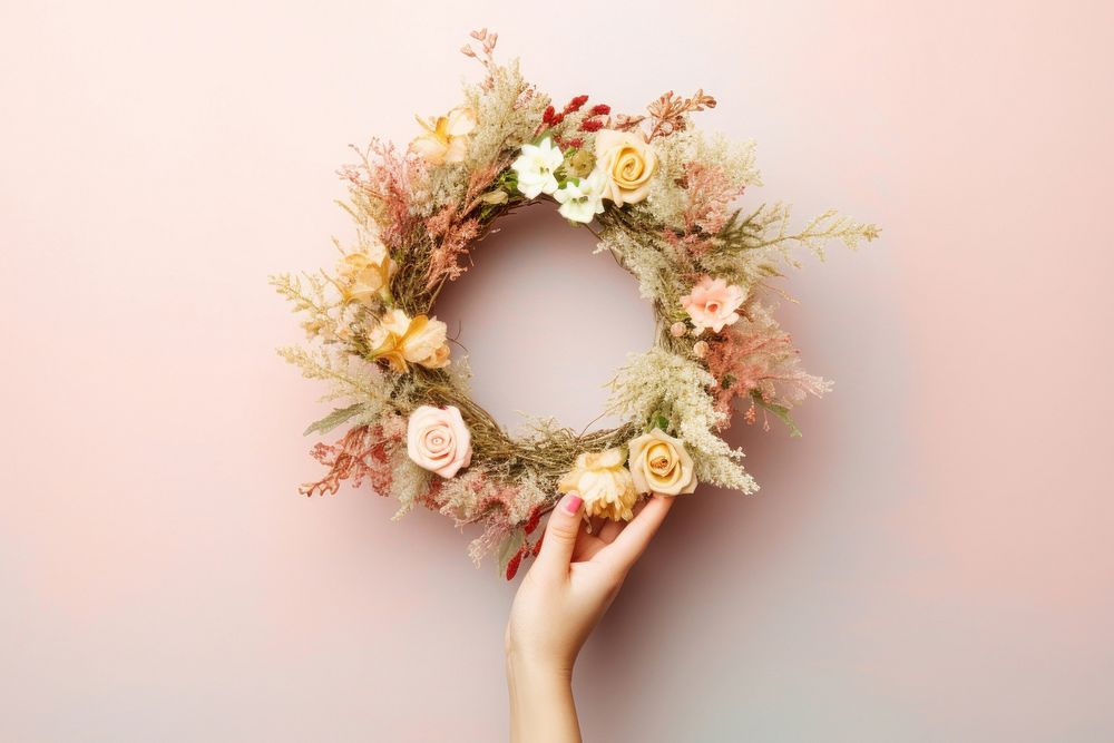 Hand holding christmas wreath celebration decoration floristry. AI generated Image by rawpixel.