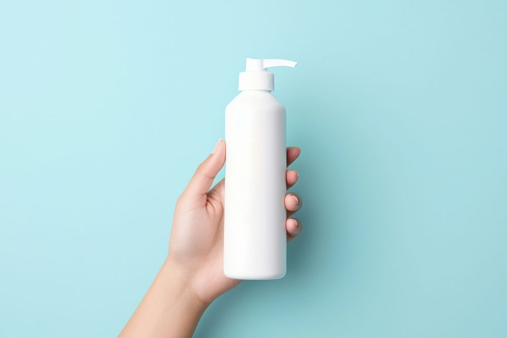 Hands holding blank white squeeze bottle blue container hygiene. AI generated Image by rawpixel.